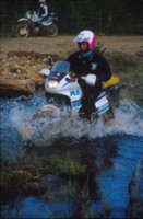 Joki-Jani Luomajoki kieli keskell suuta ja keskell jokea, jonka ylittv silta oli tulvien takia ajamattomassa kunnossa.<br>River-Jani trying to keep his tongue and DR650 in balance.